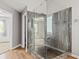 Modern shower featuring a glass enclosure and mosaic tile at 65 Millennial Ct, Lawrenceville, GA 30045