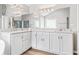 Bathroom featuring a large mirror above and double vanities at 65 Millennial Ct, Lawrenceville, GA 30045