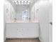 Bathroom vanity with double sink, updated fixtures and lighting, and a bright mirror at 65 Millennial Ct, Lawrenceville, GA 30045