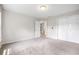 Bright carpeted bedroom with two windows and closet at 65 Millennial Ct, Lawrenceville, GA 30045
