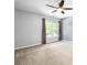 Spacious carpeted bedroom with a ceiling fan and lots of natural light at 65 Millennial Ct, Lawrenceville, GA 30045