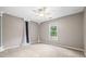 Spacious bedroom with neutral paint, crown moulding, ceiling fan, and abundant natural light at 65 Millennial Ct, Lawrenceville, GA 30045