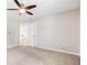 Bright carpeted bedroom with ceiling fan and views into the hallway at 65 Millennial Ct, Lawrenceville, GA 30045