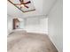 Large bedroom with neutral carpet, ceiling fan, and an adjoining fireplace at 65 Millennial Ct, Lawrenceville, GA 30045