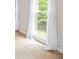 Bright bedroom featuring soft carpet, neutral walls, and a large window with sheer curtains offering views of lush greenery at 65 Millennial Ct, Lawrenceville, GA 30045