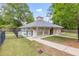 Exterior view of the well-maintained clubhouse with neutral paint, sidewalk access, and a gated pool area at 65 Millennial Ct, Lawrenceville, GA 30045
