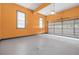 Spacious garage interior featuring an overhead door, concrete flooring and vibrant color at 65 Millennial Ct, Lawrenceville, GA 30045