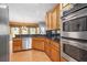 Modern kitchen featuring stainless steel appliances and wood cabinetry at 65 Millennial Ct, Lawrenceville, GA 30045