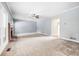 Bright living room with plush carpeting, fireplace, and neutral paint at 65 Millennial Ct, Lawrenceville, GA 30045