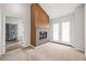 Cozy living room featuring a fireplace, carpet, and access to an adjoining bath and sunroom at 65 Millennial Ct, Lawrenceville, GA 30045