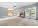 Spacious living room featuring fireplace, plush carpeting, and an open floor plan at 65 Millennial Ct, Lawrenceville, GA 30045