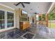 Entertainer's patio with outdoor kitchen, built-in bar, television, and slate tile flooring overlooking the private backyard at 65 Millennial Ct, Lawrenceville, GA 30045