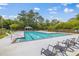 Relax in style by this large, well-maintained in-ground community pool surrounded by lounge chairs and lush greenery at 65 Millennial Ct, Lawrenceville, GA 30045