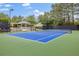 Enjoy a game of tennis on this well-maintained blue tennis court with green surround, located in a lush, well-manicured community at 65 Millennial Ct, Lawrenceville, GA 30045