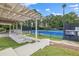 Community tennis courts with pergola, benches, and a pristine blue and green playing surface, surrounded by trees at 65 Millennial Ct, Lawrenceville, GA 30045