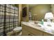 Bathroom with a vanity, toilet, shower with striped curtain, and matching towel at 208 Eagles Flight, Villa Rica, GA 30180