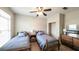Cozy bedroom with two twin beds, ceiling fan, and ample natural light at 208 Eagles Flight, Villa Rica, GA 30180