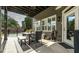 Charming covered patio with outdoor dining set, ceiling fans, and access to the backyard and pool area at 208 Eagles Flight, Villa Rica, GA 30180