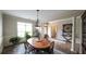 Elegant dining room with natural light, decorative columns and stylish chandelier fixture at 208 Eagles Flight, Villa Rica, GA 30180
