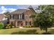 Stunning home showcasing a stone and stucco facade, lush landscaping, and a welcoming front entrance at 208 Eagles Flight, Villa Rica, GA 30180