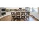 Bright, open kitchen with an island bar, stainless steel appliances, and wood flooring at 208 Eagles Flight, Villa Rica, GA 30180