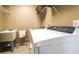 Functional laundry room with white appliances, sink and wire racks for storage at 208 Eagles Flight, Villa Rica, GA 30180