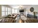 Inviting living room with bright windows, ceiling fan, and plush furniture at 208 Eagles Flight, Villa Rica, GA 30180