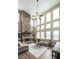 Bright living room boasts a stone fireplace, ceiling fan, and multiple windows at 208 Eagles Flight, Villa Rica, GA 30180