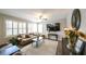Spacious living room with plantation shutters, ceiling fan and cozy seating arrangement at 208 Eagles Flight, Villa Rica, GA 30180
