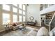 Bright and airy living room with high ceilings, large windows, and modern decor at 208 Eagles Flight, Villa Rica, GA 30180