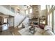 Open-concept living room features a stone fireplace, staircase and lots of natural light at 208 Eagles Flight, Villa Rica, GA 30180