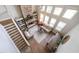 Aerial view of a living room features stone fireplace and adjacent staircase at 208 Eagles Flight, Villa Rica, GA 30180
