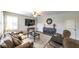 Comfortable living room features a ceiling fan, bright windows, and a modern entertainment center at 208 Eagles Flight, Villa Rica, GA 30180