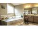 Bright bathroom with tiled garden tub and vanity with lots of counter space at 208 Eagles Flight, Villa Rica, GA 30180