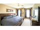 Comfortable main bedroom features a queen bed, side table, dark curtains, and dresser with mirror at 208 Eagles Flight, Villa Rica, GA 30180