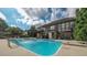 Inviting backyard with a sparkling pool, lounge chairs, a diving board, and a covered outdoor dining area at 208 Eagles Flight, Villa Rica, GA 30180