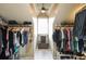 This large walk-in closet has ample hanging space and window for natural light at 208 Eagles Flight, Villa Rica, GA 30180