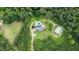 Stunning aerial view of estate home with pool, detached garage and circular drive nestled amongst mature trees at 2997 Happy Hollow Se Dr, Conyers, GA 30094