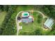 Aerial view of the property showcasing the house, pool, barn, and surrounding greenery at 2997 Happy Hollow Se Dr, Conyers, GA 30094