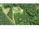 Aerial view of property showcasing the home, outbuilding, pool, and surrounding greenery at 2997 Happy Hollow Se Dr, Conyers, GA 30094