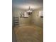 Finished basement space with unique chandelier, tiled floors, shelving, and storage cabinets at 2997 Happy Hollow Se Dr, Conyers, GA 30094