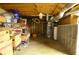 Unfinished basement featuring exposed ceiling, wall shelving, and utilities at 2997 Happy Hollow Se Dr, Conyers, GA 30094