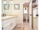 Well-lit bathroom featuring a vanity with drawers, decorative accents, and tile flooring at 2997 Happy Hollow Se Dr, Conyers, GA 30094