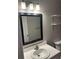 Bathroom with a white sink, black mirror, and bright lighting at 2997 Happy Hollow Se Dr, Conyers, GA 30094