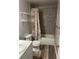 Bathroom featuring a shower/tub combo with decorative curtain and gray tiled walls at 2997 Happy Hollow Se Dr, Conyers, GA 30094