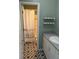 Cozy bathroom featuring patterned tile floor, a sink with vanity, and shower with patterned curtain at 2997 Happy Hollow Se Dr, Conyers, GA 30094