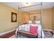 Bedroom featuring a four-poster bed, hardwood floors, and decorative accents at 2997 Happy Hollow Se Dr, Conyers, GA 30094