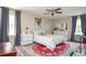 Cozy bedroom with neutral tones, ceiling fan, and an area rug at 2997 Happy Hollow Se Dr, Conyers, GA 30094
