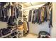 Walk-in closet with white shelves and hanging rods filled with clothes, shoes, and bags at 2997 Happy Hollow Se Dr, Conyers, GA 30094