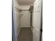 Walk-in closet with shelving, clothing rack, and carpeted floor at 2997 Happy Hollow Se Dr, Conyers, GA 30094